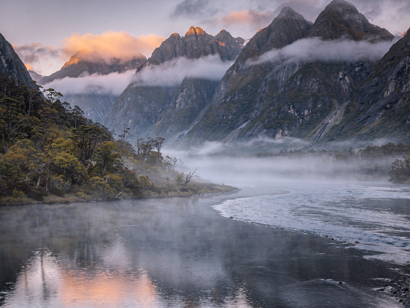 Mitre peak shrouded in atmospheric fjord mist
